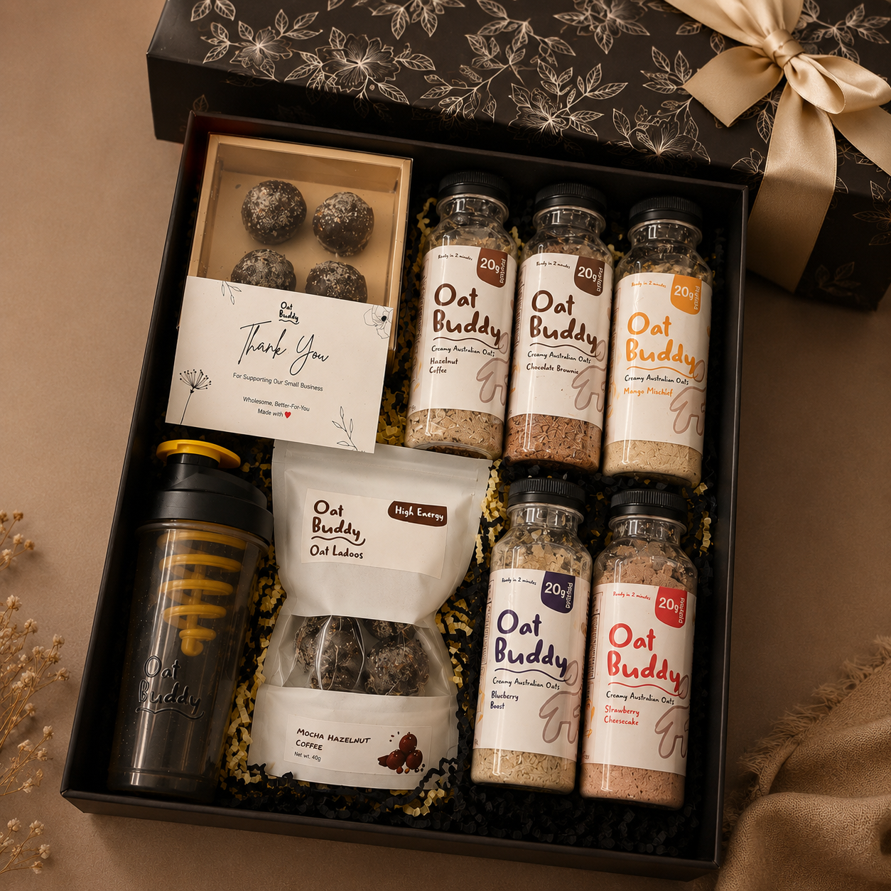 OatBuddy gift box packed with oats, ladoos, sipper and a thank you card